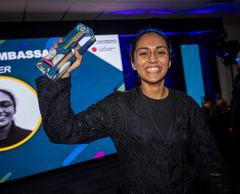 The former apprentice, now a tutor, holding an award